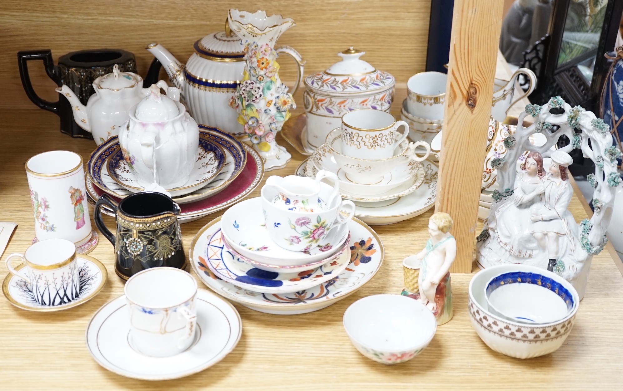 A large collection of mixed 19th century tea ware, a Staffordshire flat back, floral encrusted vase
